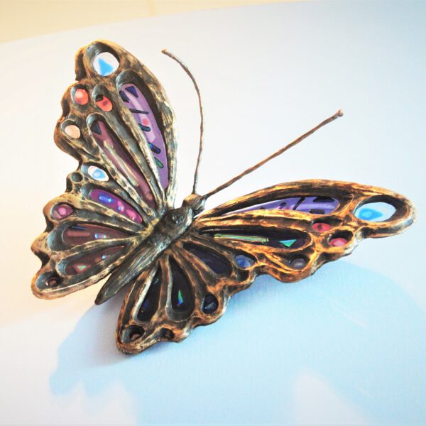 vlinder in brons en glas